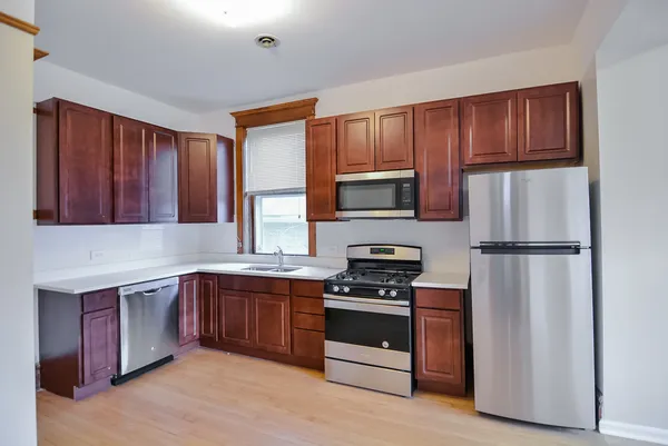 a kitchen with stainless steel appliances a refrigerator stove and microwave