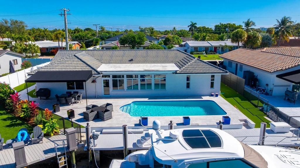 a aerial view of a house with swimming pool garden and patio
