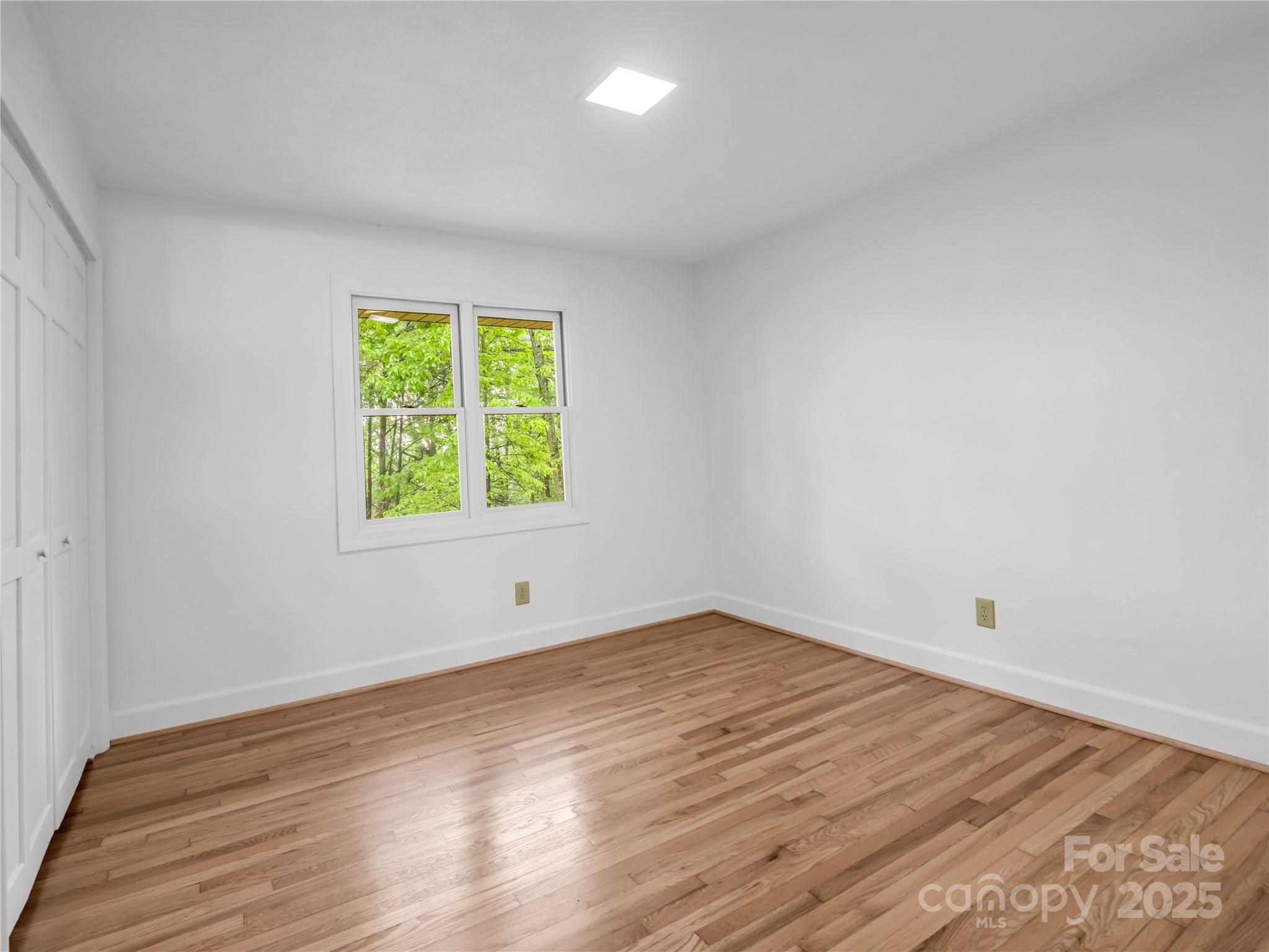 200 Little Wings Mountain Road Columbus, NC 28722 - Photo 19 of 42 wooden floor in an empty room with a window