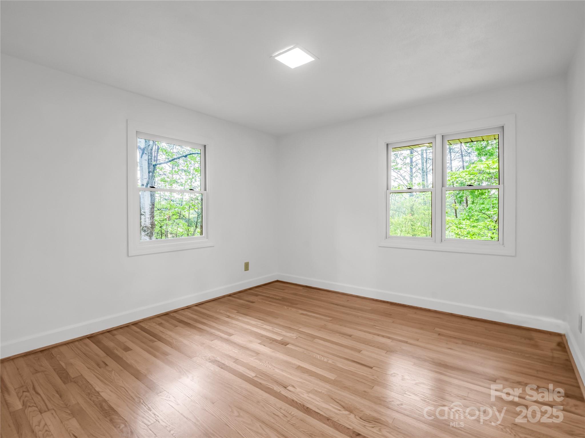 200 Little Wings Mountain Road Columbus, NC 28722 - Photo 21 of 42 an empty room with a window