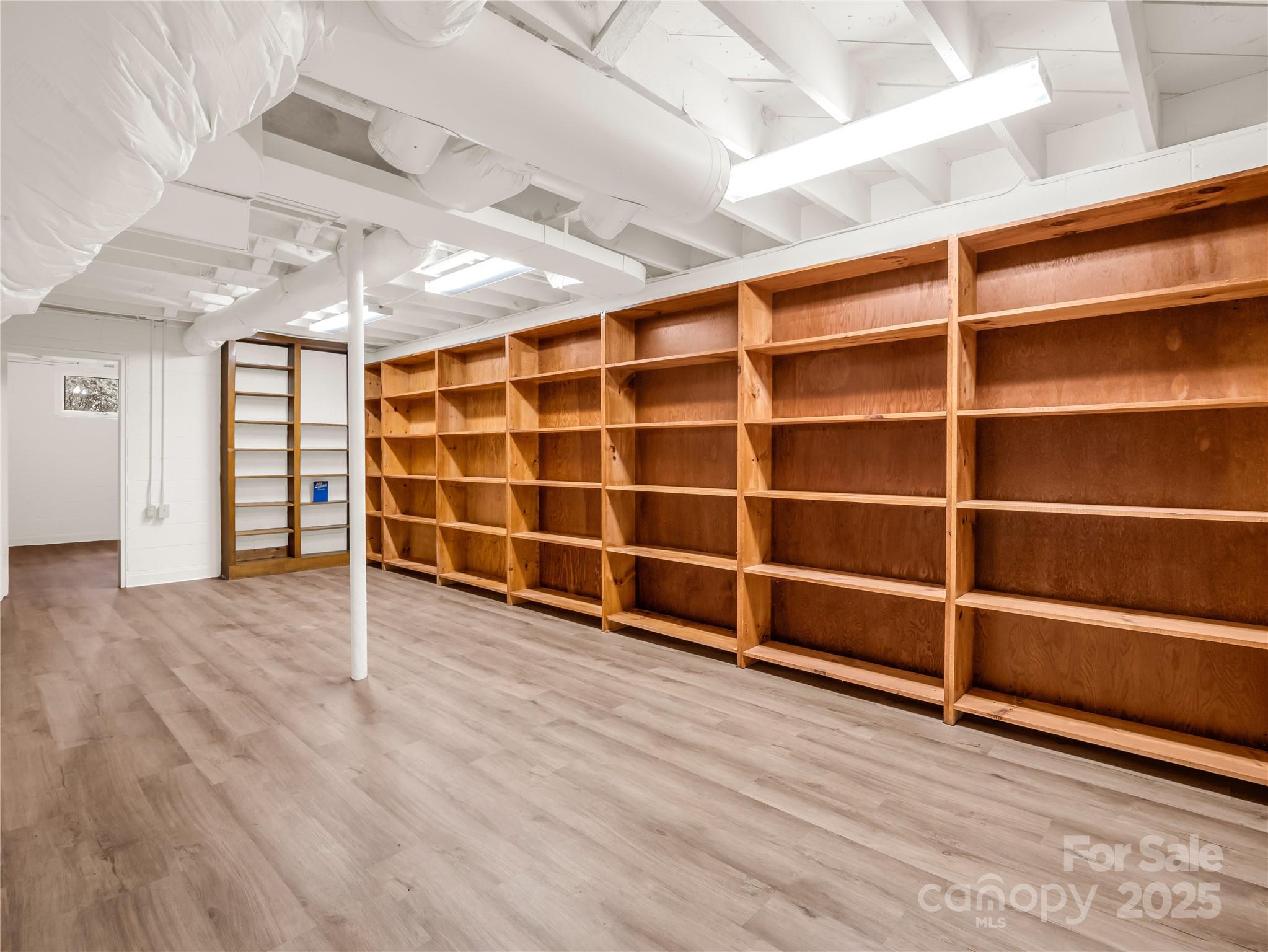 200 Little Wings Mountain Road Columbus, NC 28722 - Photo 24 of 42 a view of an empty room with wooden floor and windows