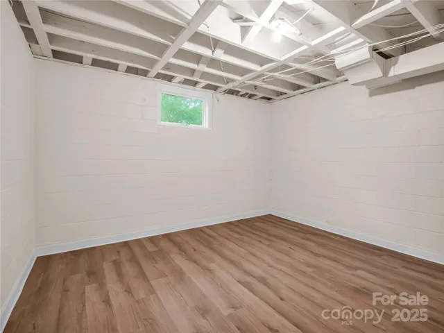 a view of a room with wooden floor
