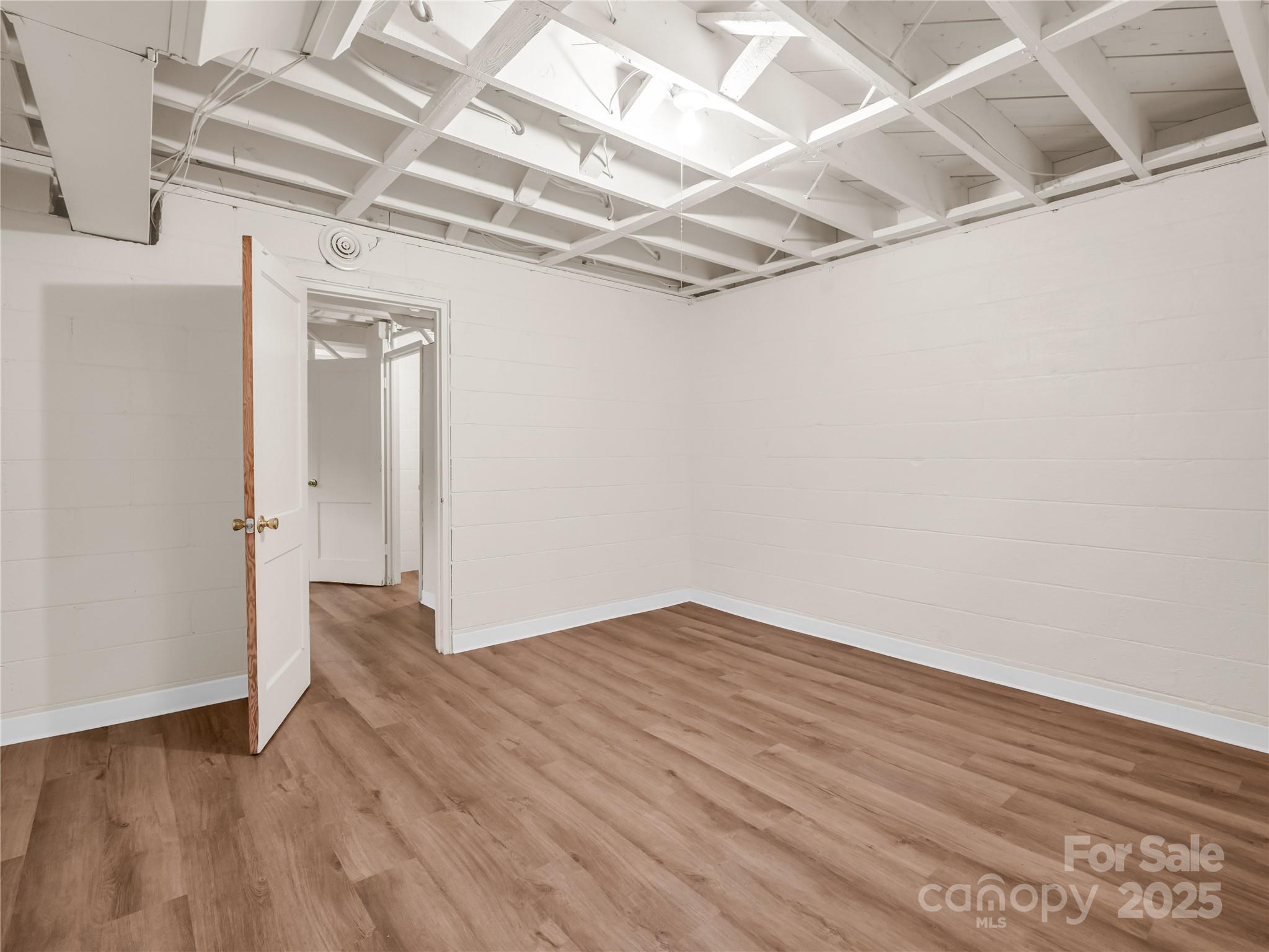 200 Little Wings Mountain Road Columbus, NC 28722 - Photo 27 of 42 an empty room with wooden floor and windows