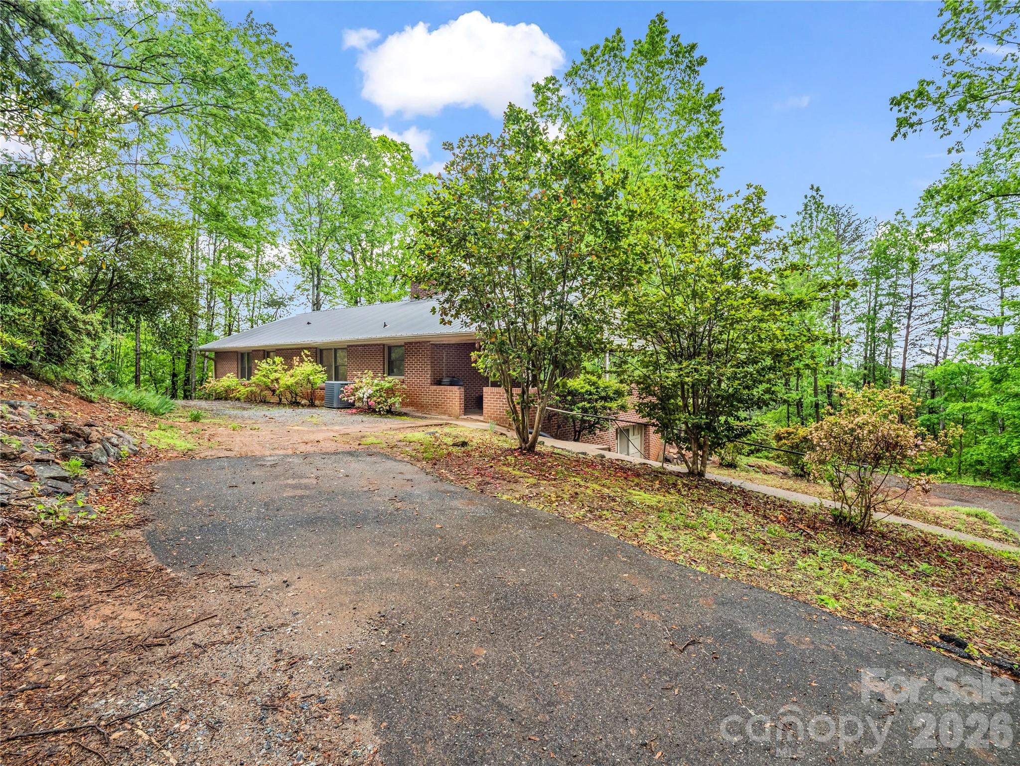 200 Little Wings Mountain Road Columbus, NC 28722 - Photo 3 of 42 a front view of a house with a yard and a garage