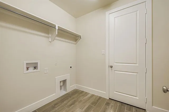 a view of a room with wooden floor