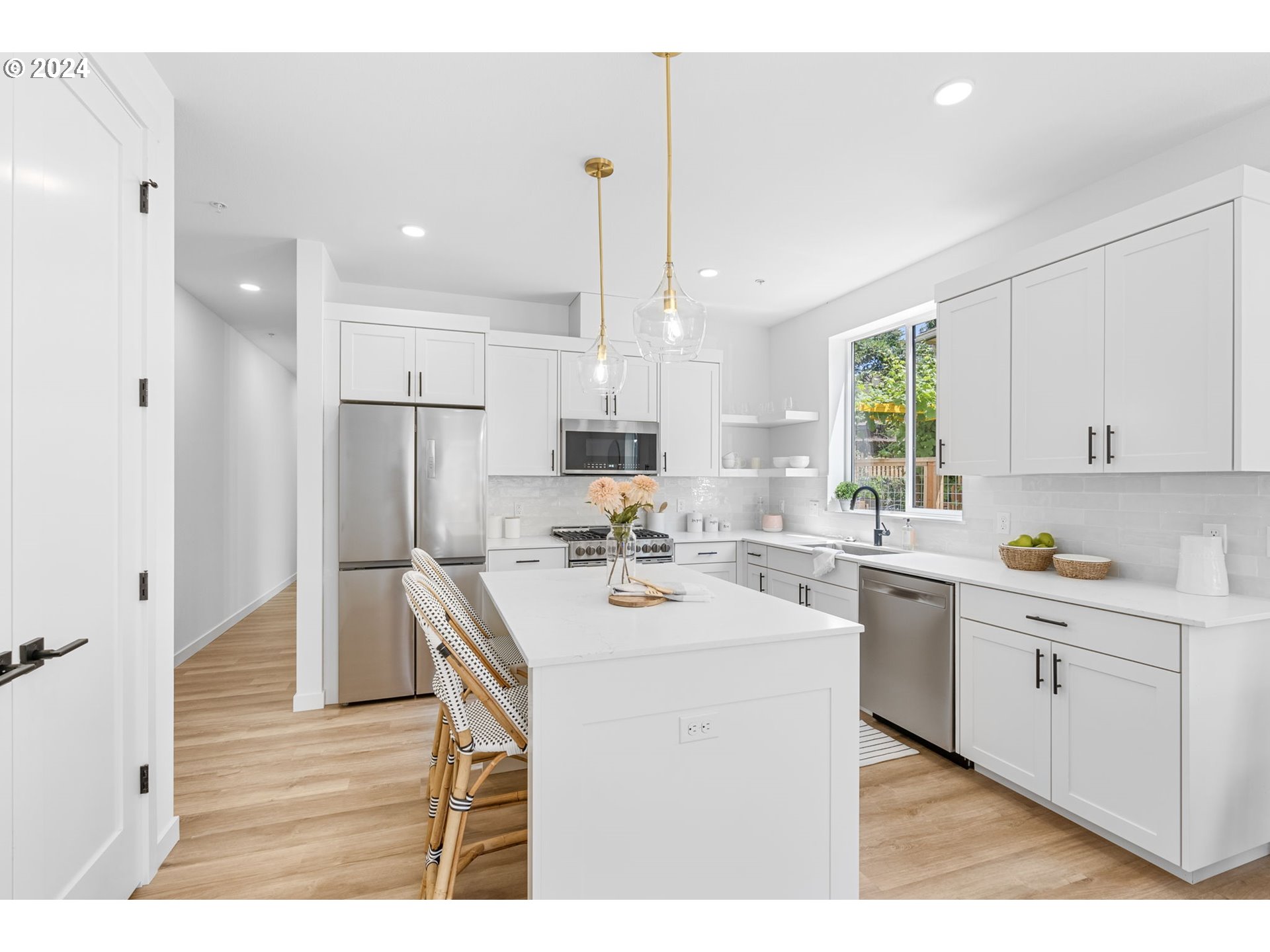 121 North Going Street, Unit 202 Portland, OR 97217 - Photo 2 of 30 a kitchen that has a lot of cabinets in it and appliances