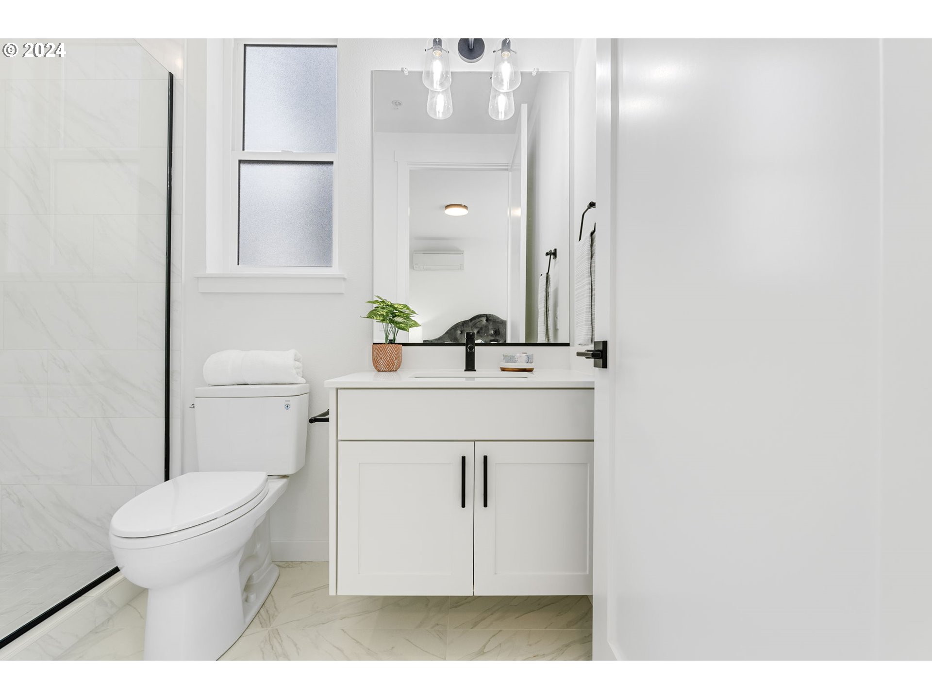 121 North Going Street, Unit 202 Portland, OR 97217 - Photo 23 of 30 a bathroom with a sink toilet and mirror