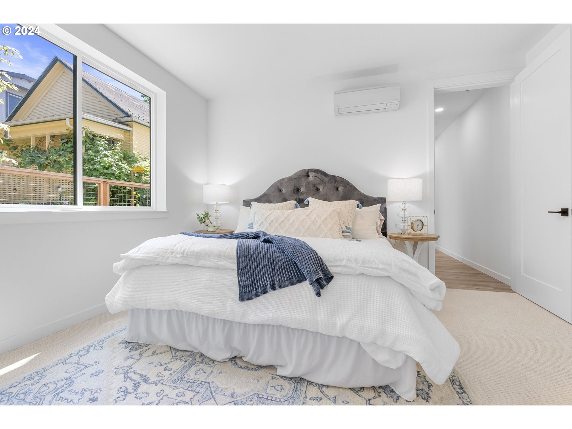 121 North Going Street, Unit 202 Portland, OR 97217 - Photo 24 of 30 a bedroom with a bed and a large window