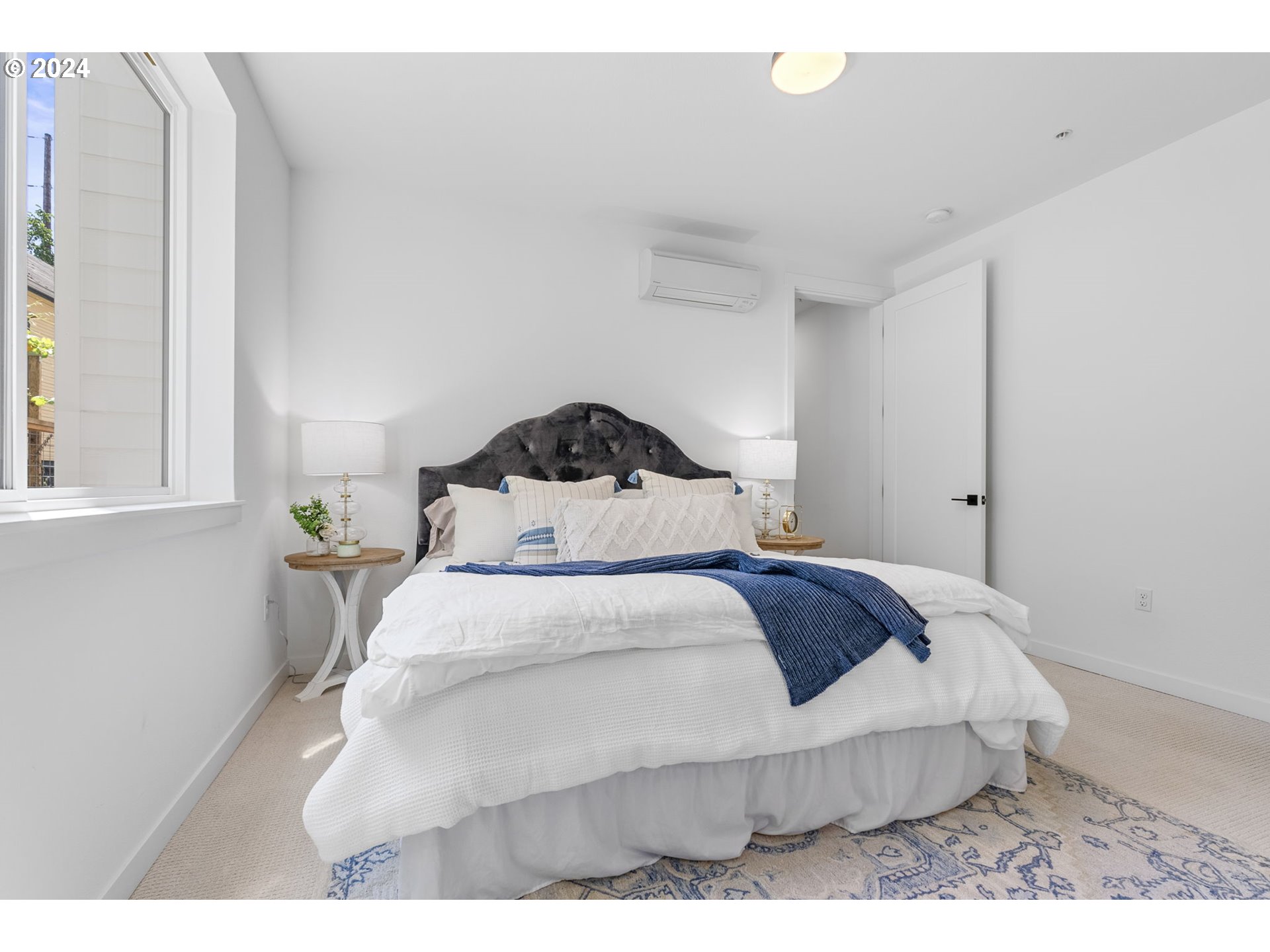 121 North Going Street, Unit 202 Portland, OR 97217 - Photo 25 of 30 a bedroom with a bed and a window