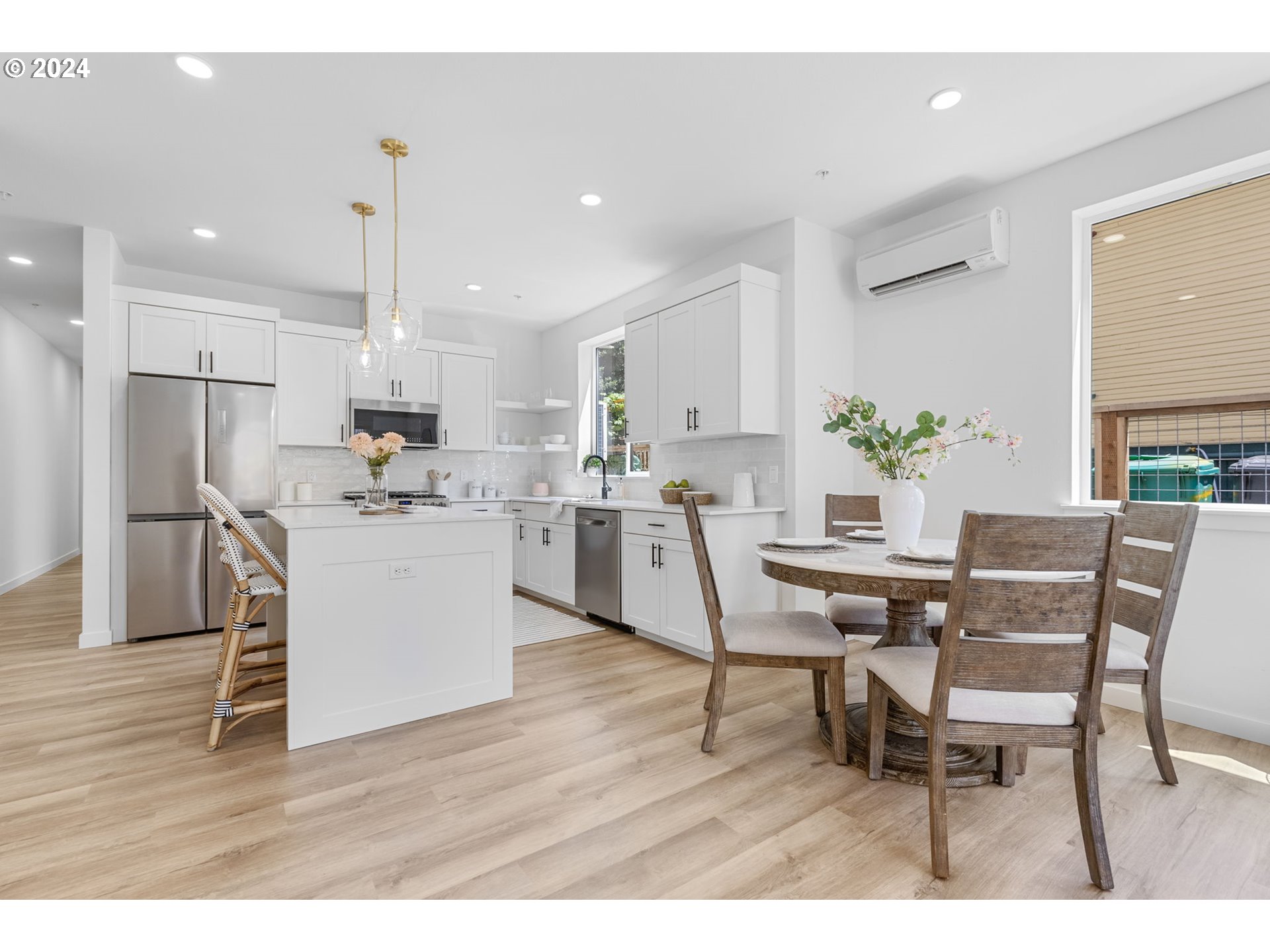 121 North Going Street, Unit 202 Portland, OR 97217 - Photo 28 of 30 a living room with kitchen island furniture and a wooden floor