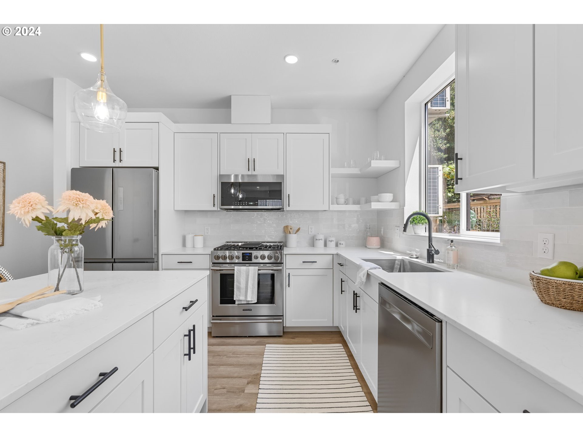 121 North Going Street, Unit 202 Portland, OR 97217 - Photo 9 of 30 a kitchen with stainless steel appliances granite countertop a sink a stove a refrigerator cabinets and a window