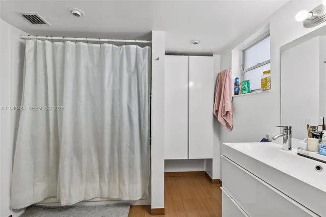 a bathroom with a shower curtain and a sink