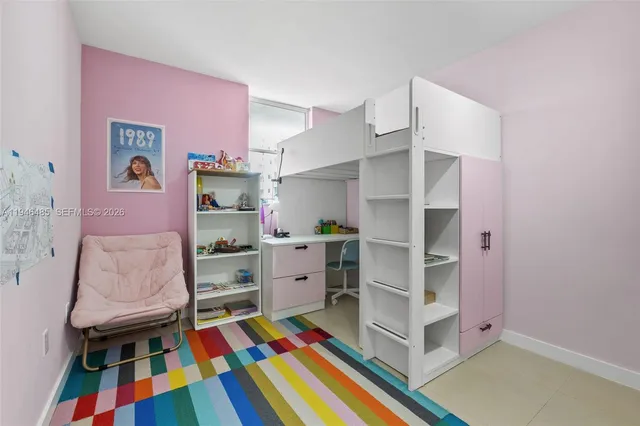 a room with furniture and a baby crib