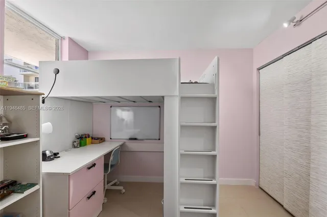 a kitchen with a refrigerator and white cabinets