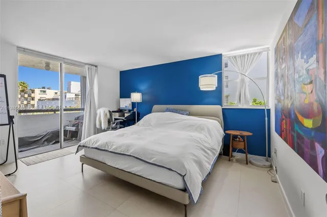 a bedroom with a bed and dresser with mirror