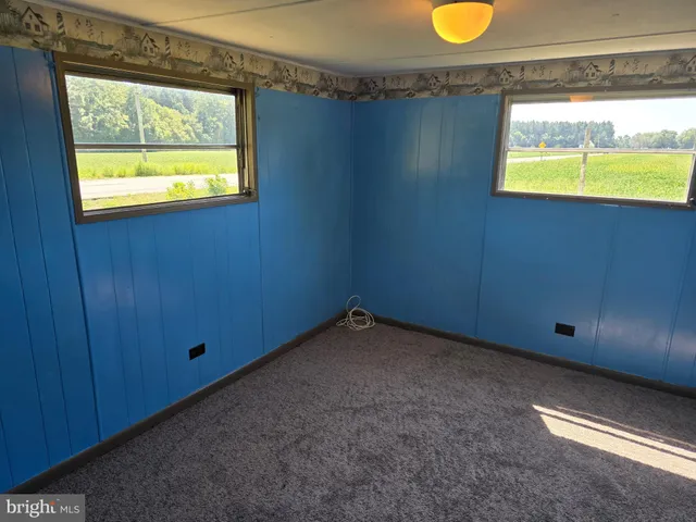 a view of an empty room and a window