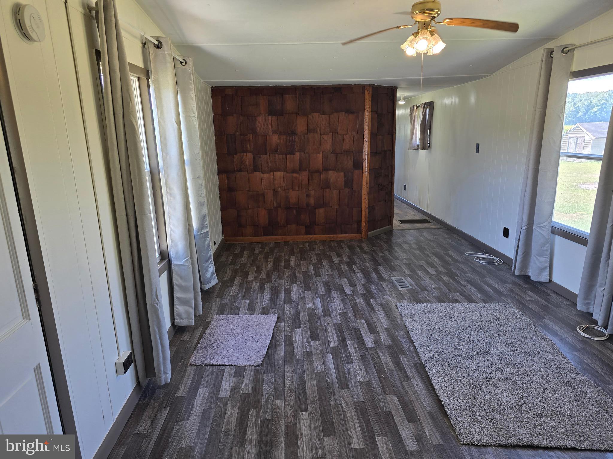 4662 Powellville Road Pittsville, MD 21850 - Photo 2 of 34 wooden floor in an empty room with a bathroom