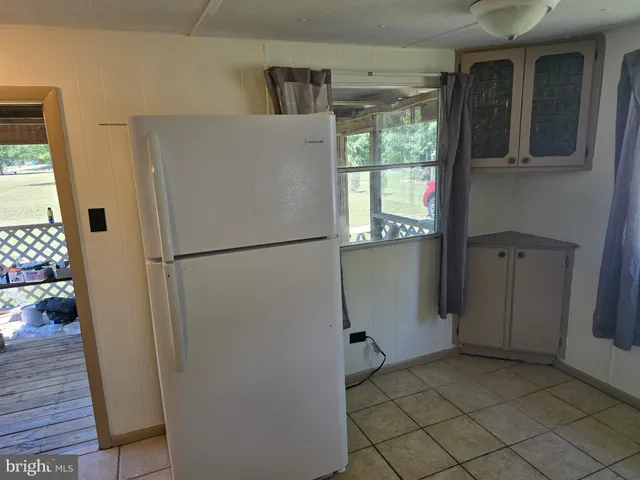 a refrigerator freezer sitting inside of a kitchen