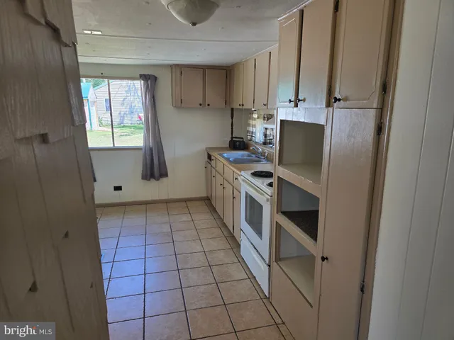 a kitchen with a stove a sink and a refrigerator