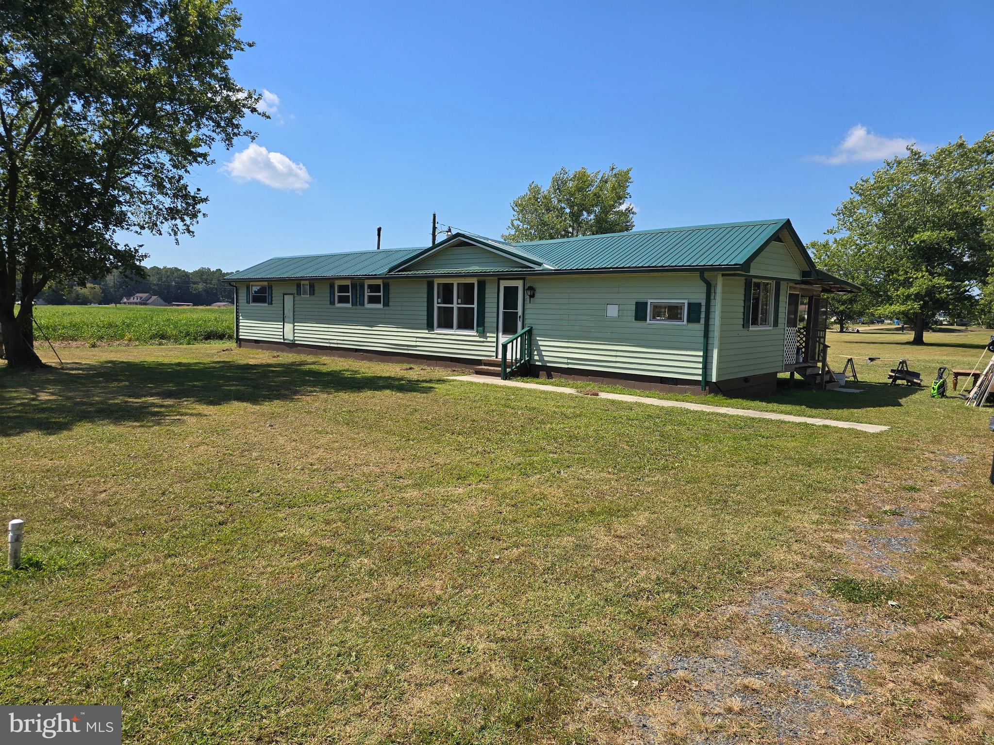 4662 Powellville Road Pittsville, MD 21850 - Photo 8 of 34 a front view of a house with a yard