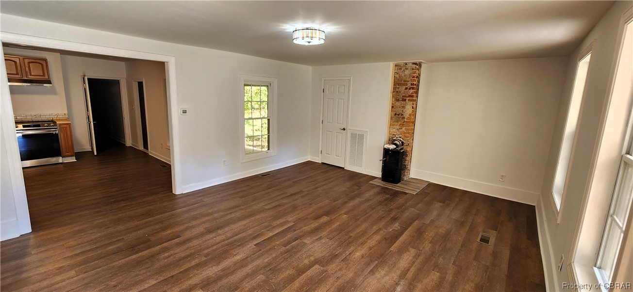 773 Crab Neck Road Hudgins, VA 23076 - Photo 4 of 27 Living Room with exposed brick chimney and 1700 BTU woodstove for cozy evenings!