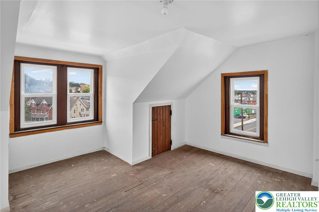 1106 Broadway Bethlehem, PA 18015 - Photo 23 of 25 a view of an empty room with a window and wooden floor