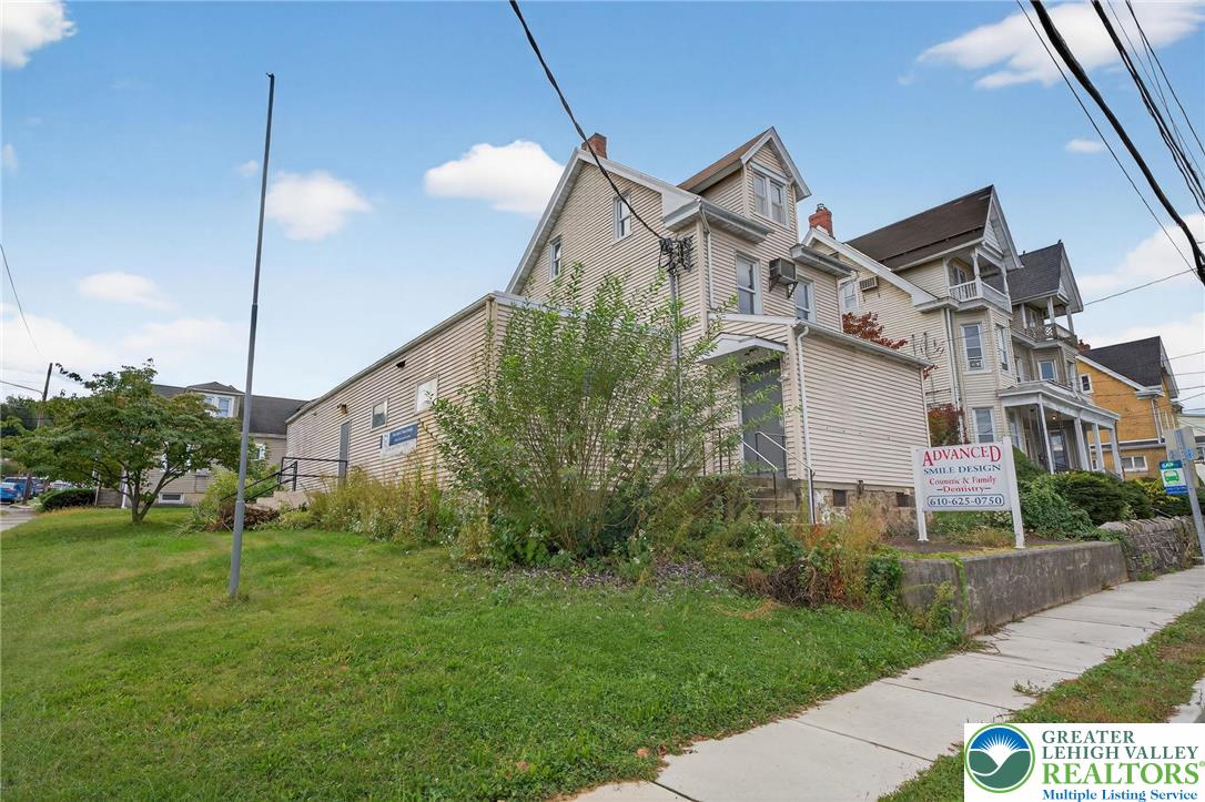 1106 Broadway Bethlehem, PA 18015 - Photo 25 of 25 a view of a white house next to a yard with big trees
