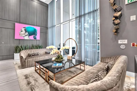 a very nice looking room with gym equipment and large windows