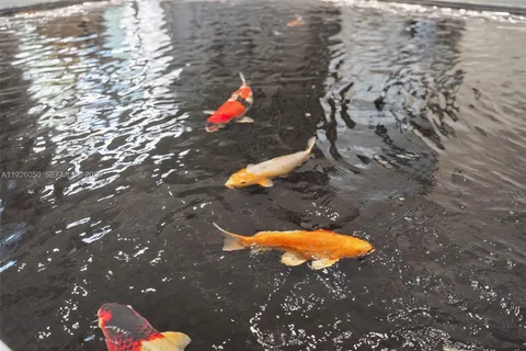 a view of a house with swimming pool and sitting area