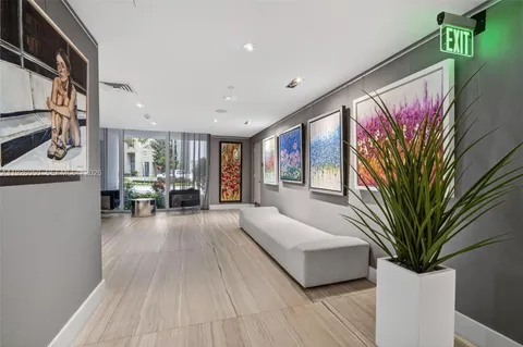 a view of a hallway view with staircase and a bathroom