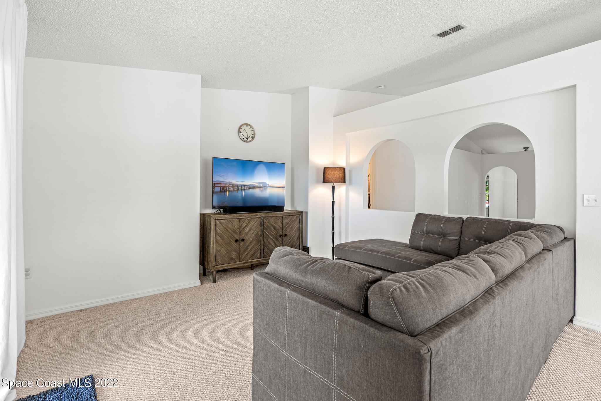 1920 Brookshire Circle Melbourne, FL 32904 - Photo 15 of 41 a living room with furniture and a flat screen tv