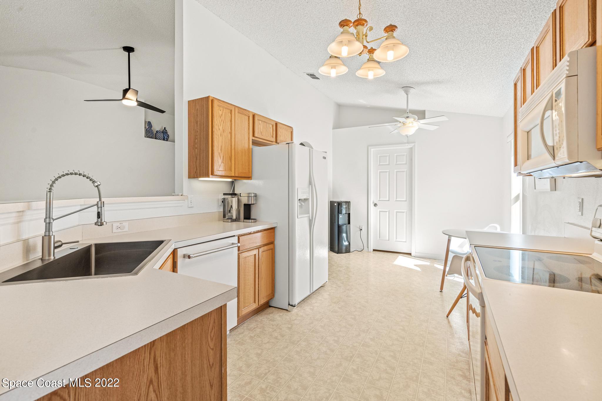 1920 Brookshire Circle Melbourne, FL 32904 - Photo 18 of 41 a kitchen with a sink appliances and a counter top space