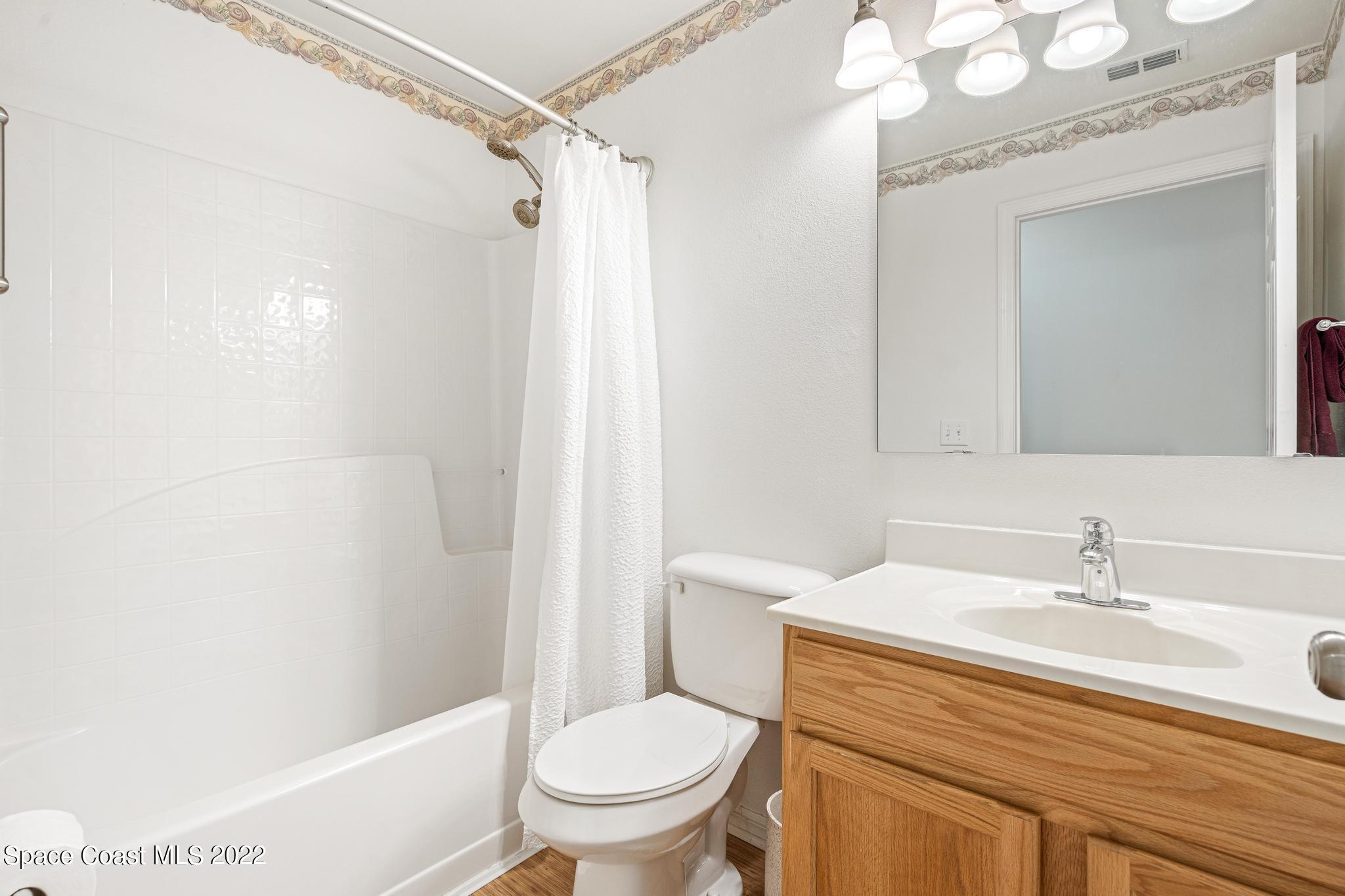 1920 Brookshire Circle Melbourne, FL 32904 - Photo 26 of 41 a bathroom with a sink a toilet and shower