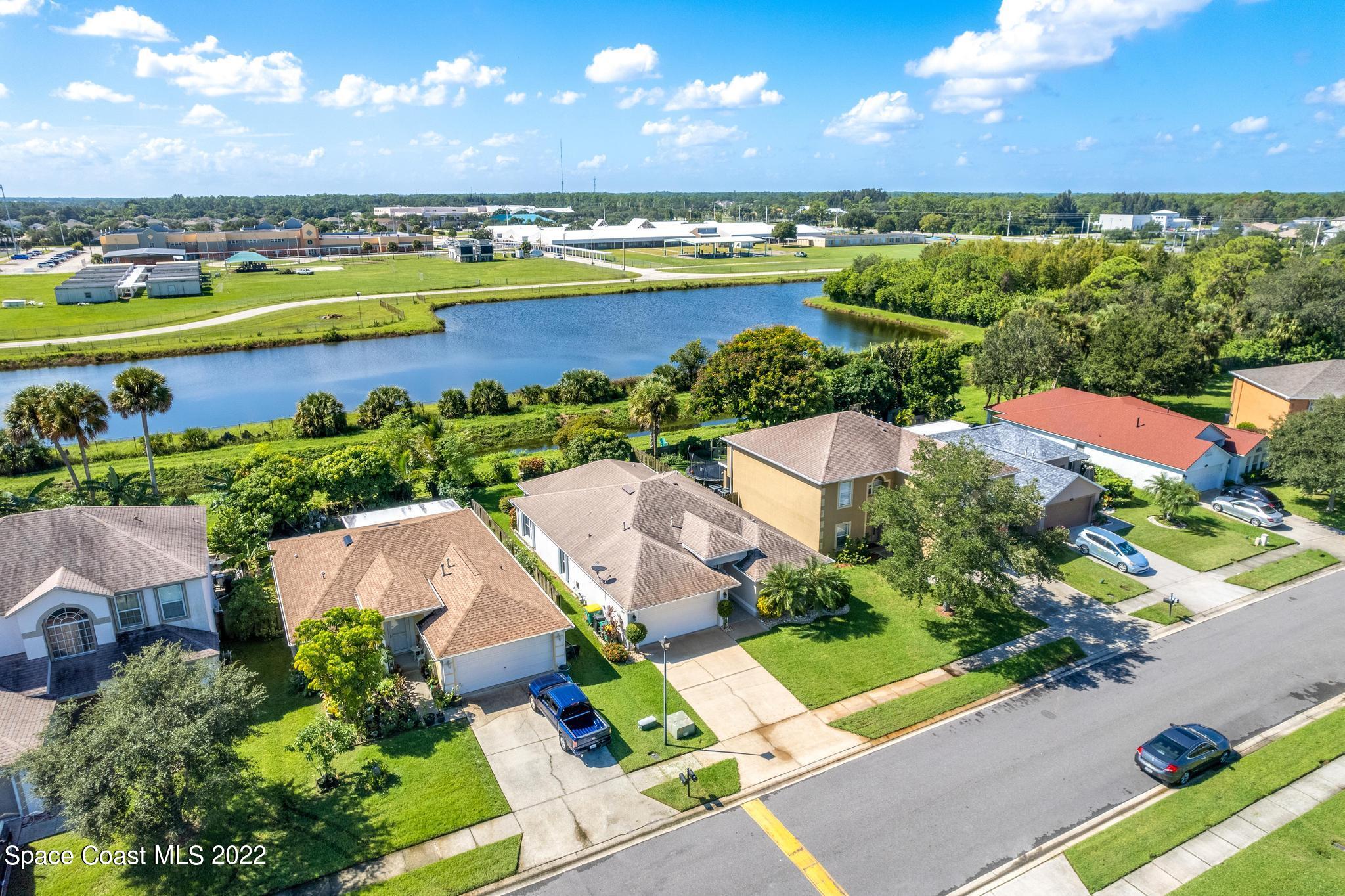 1920 Brookshire Circle Melbourne, FL 32904 - Photo 34 of 41 an aerial view of residential houses with outdoor space and lake view
