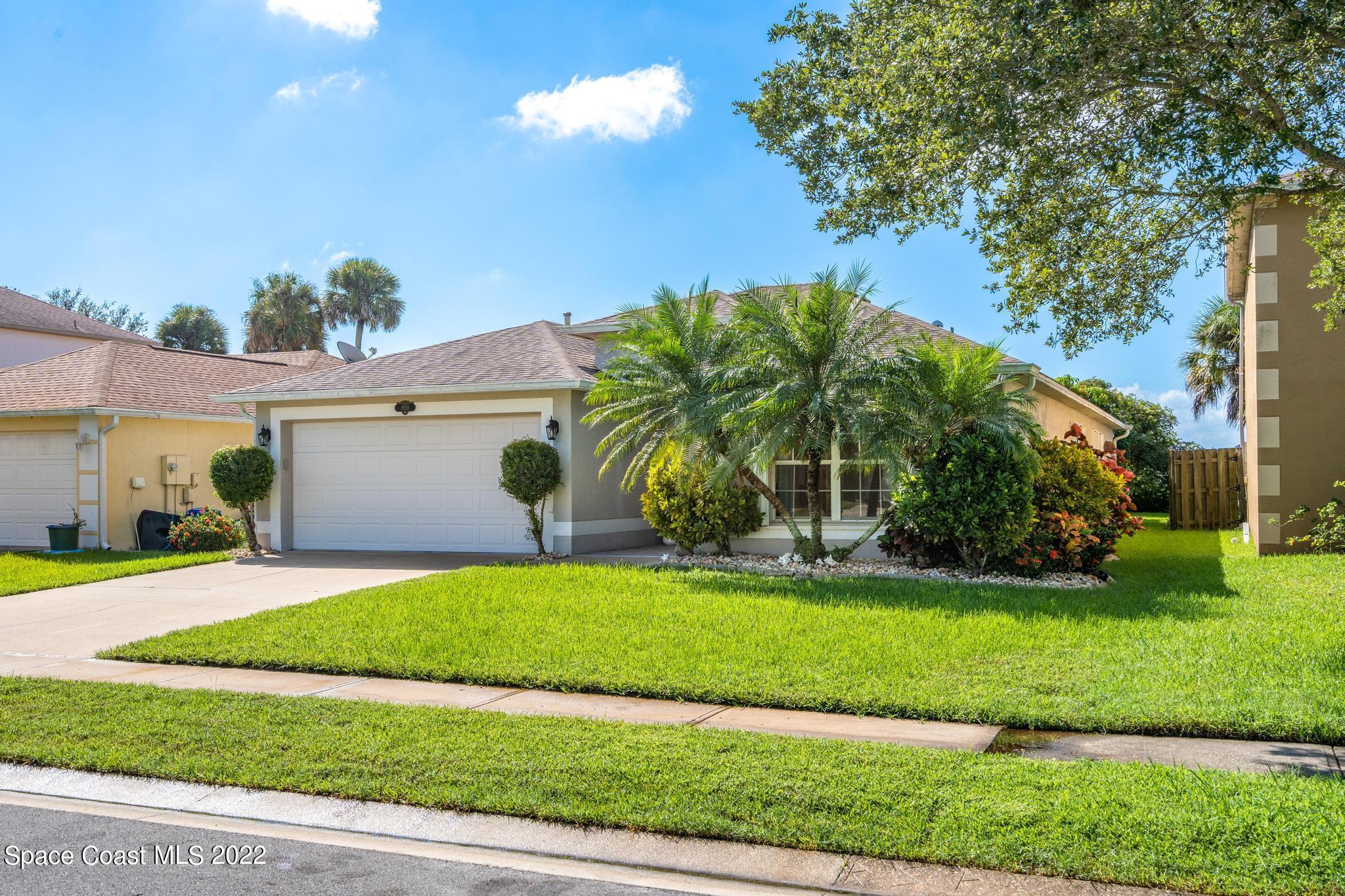 1920 Brookshire Circle Melbourne, FL 32904 - Photo 4 of 41 a view of a house with a yard and a garage