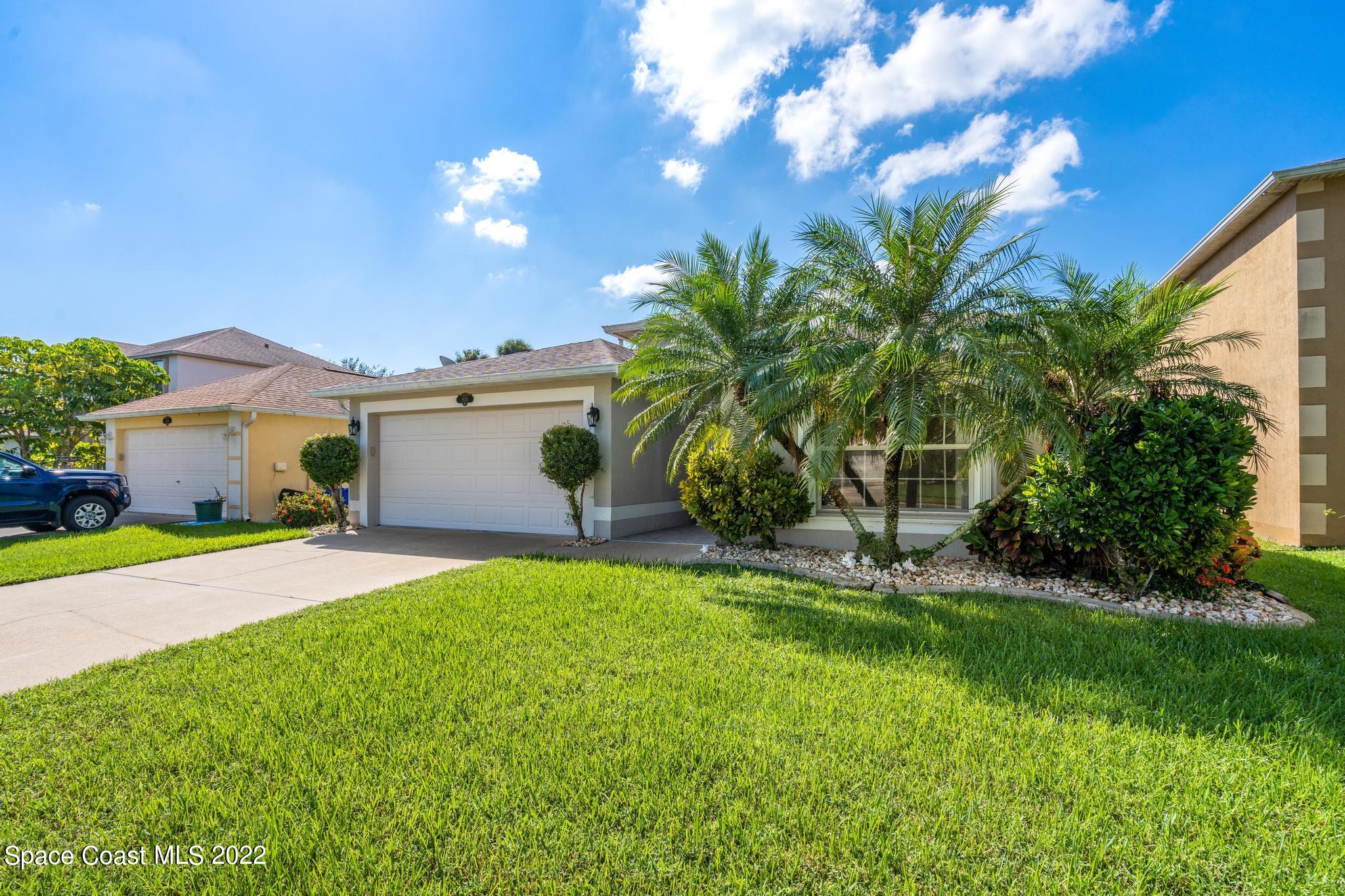 1920 Brookshire Circle Melbourne, FL 32904 - Photo 5 of 41 a front view of house with yard and garage
