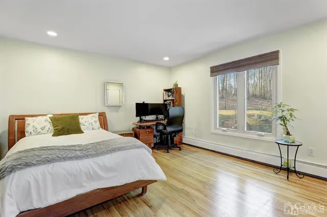 a bedroom with a bed a table and a large window