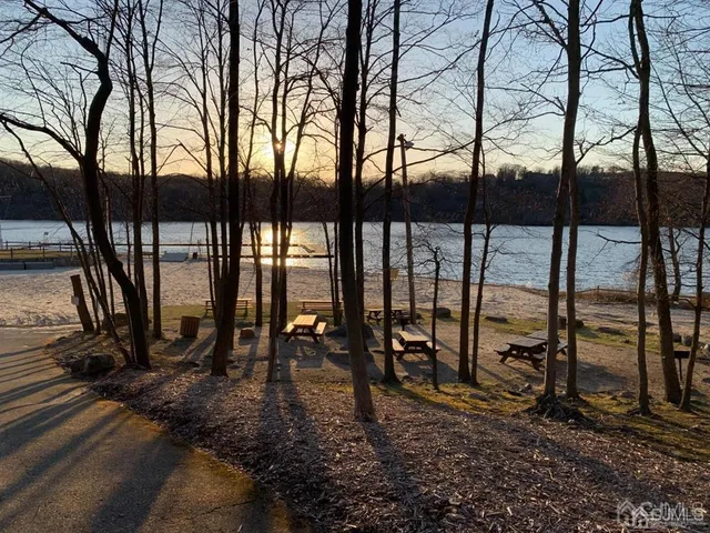 a view of a lake with sunset