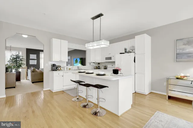 a spacious bedroom with a bed a couch and large window