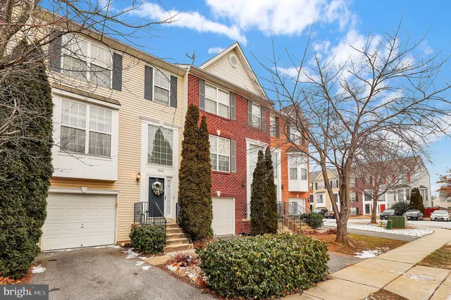 a front view of a building with a garden