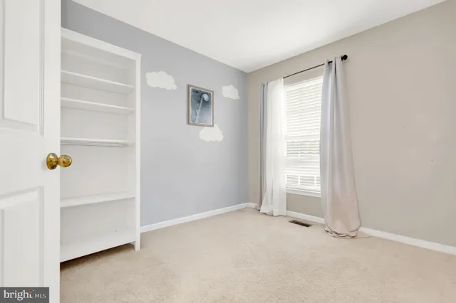 a living room with furniture and a book shelf