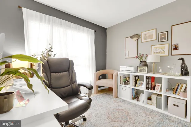 a living room with furniture and a large window with outer view