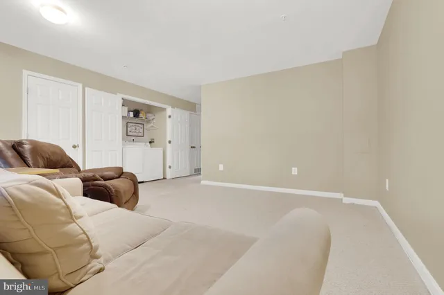 a living room with furniture and white walls