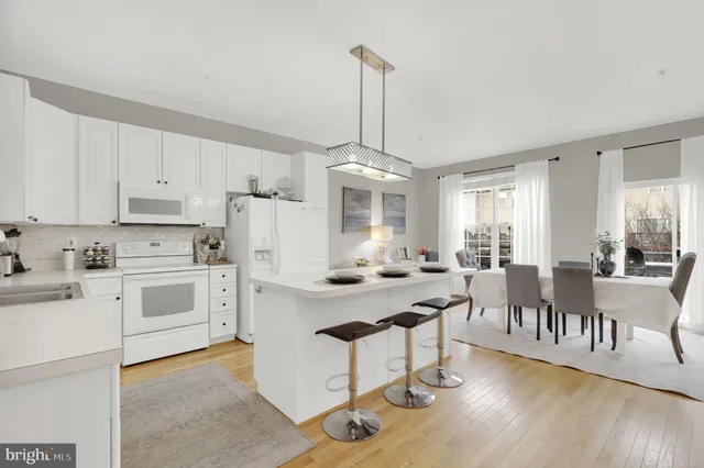 a kitchen with white cabinets sink and white appliances
