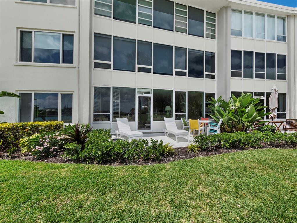 100 Sands Point Road, Unit 108 Longboat Key, FL 34228 - Photo 11 of 46 a front view of a building with a garden and plants