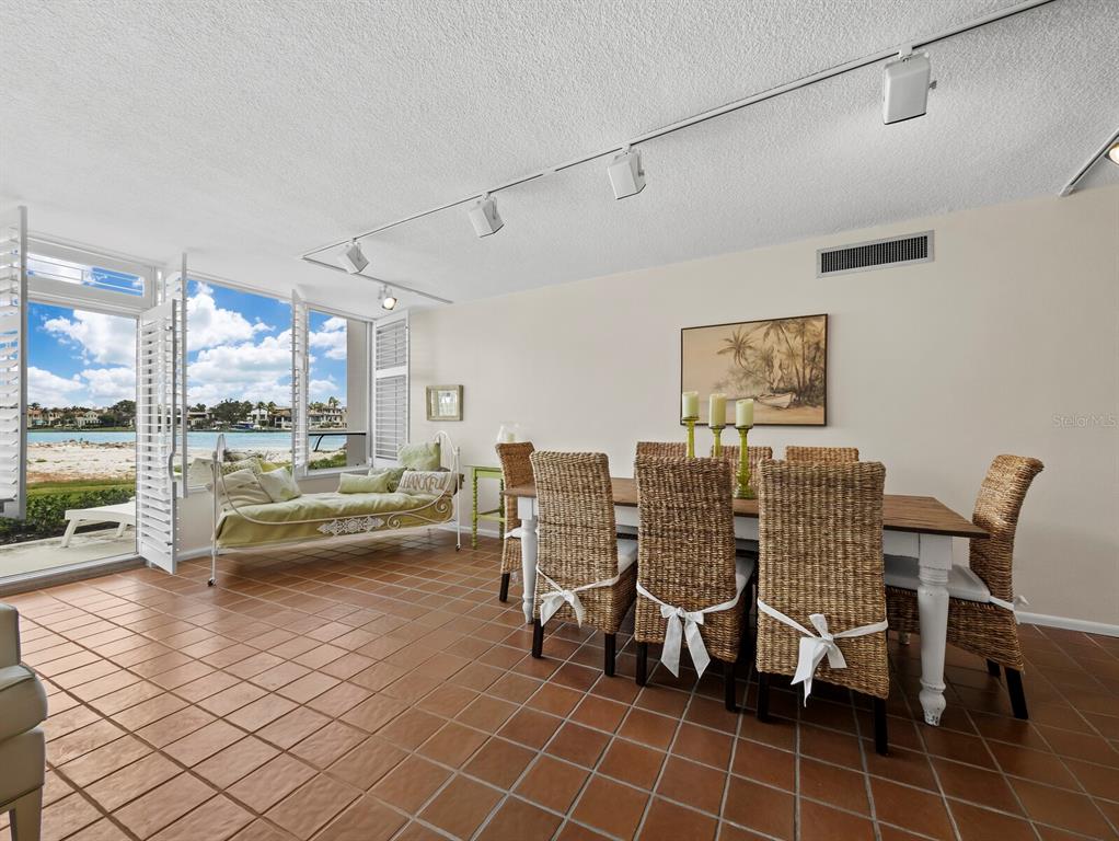 100 Sands Point Road, Unit 108 Longboat Key, FL 34228 - Photo 13 of 46 a dining room with furniture and wooden floor