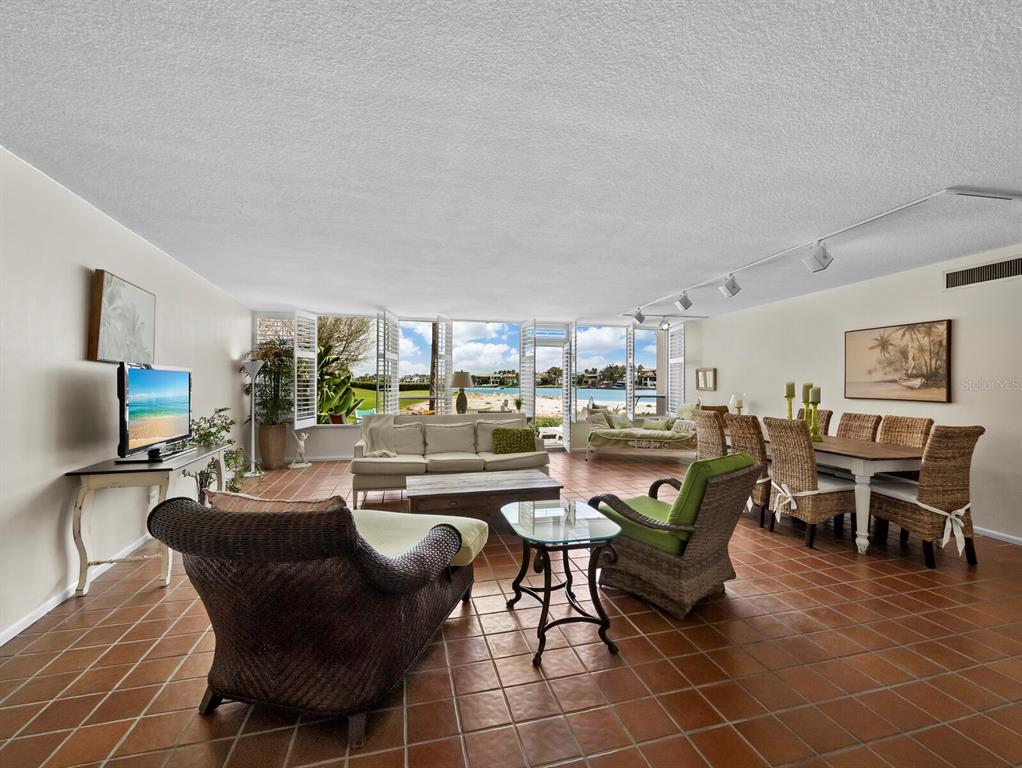 100 Sands Point Road, Unit 108 Longboat Key, FL 34228 - Photo 14 of 46 a dining room with lots of furniture and rug