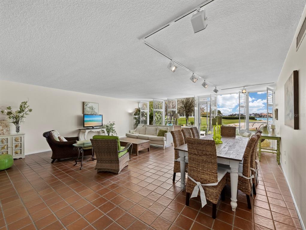100 Sands Point Road, Unit 108 Longboat Key, FL 34228 - Photo 15 of 46 a dining room with furniture and outdoor view