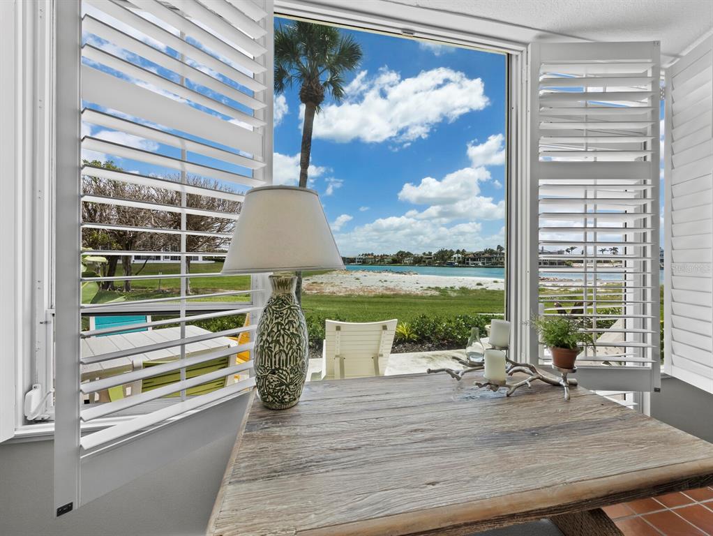 100 Sands Point Road, Unit 108 Longboat Key, FL 34228 - Photo 16 of 46 a view of a porch with furniture and garden