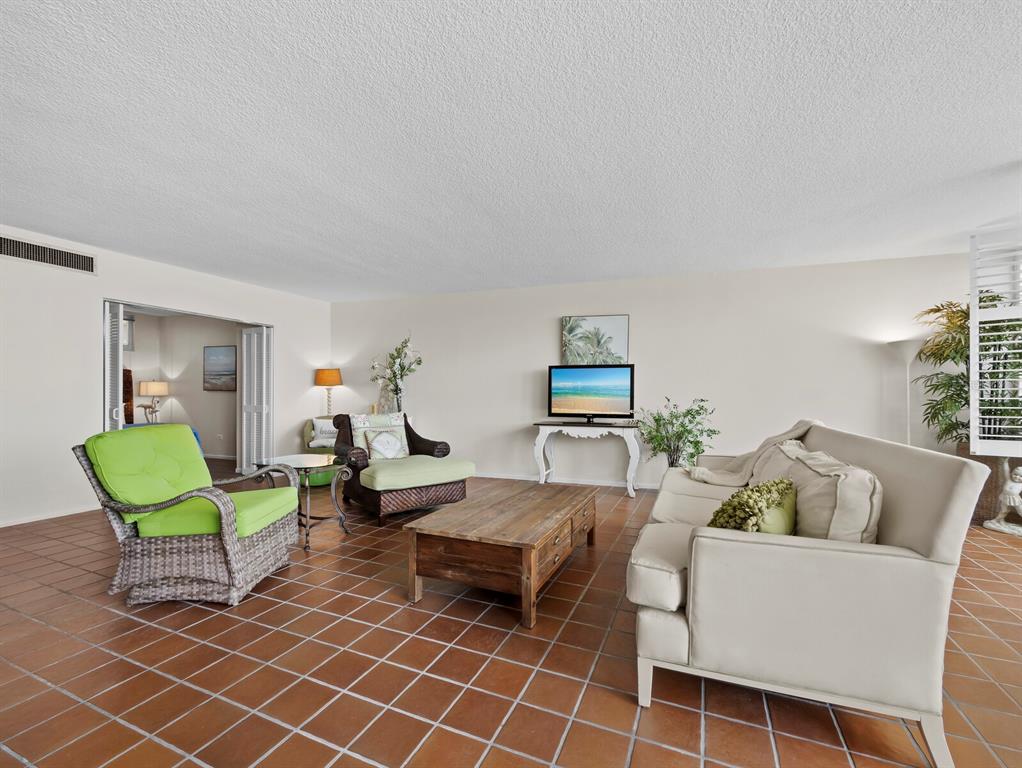 100 Sands Point Road, Unit 108 Longboat Key, FL 34228 - Photo 17 of 46 a living room with furniture a table and chair